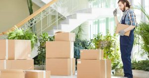 pensive-moving-specialist-counting-delivered-boxes