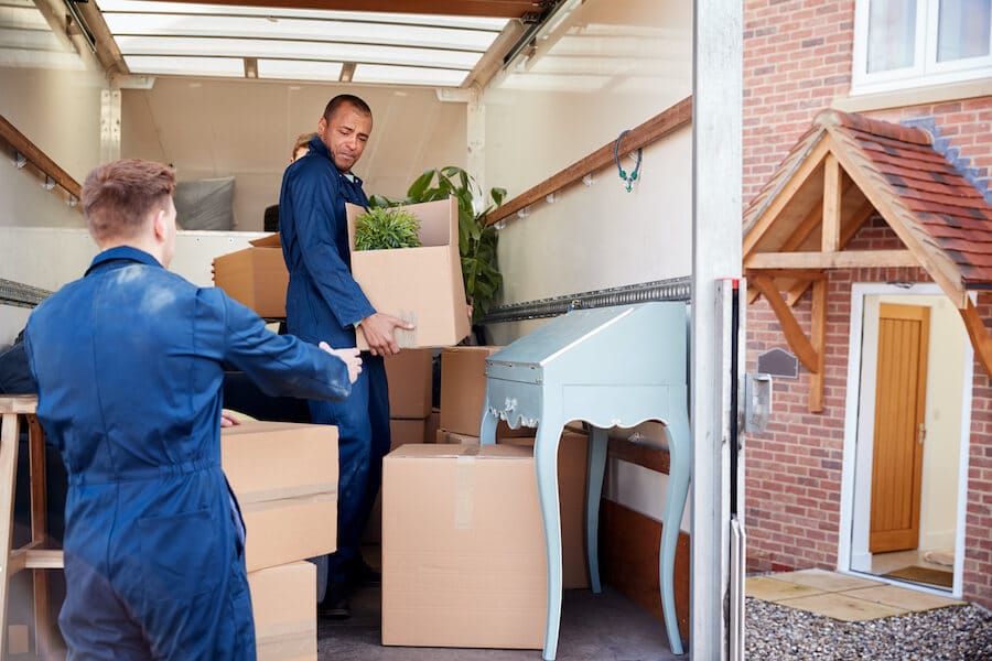 moving-company-workers-unloading-furniture-and-boxe