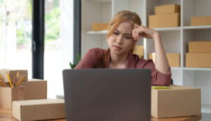 Confused young woman researching moving company quotes.