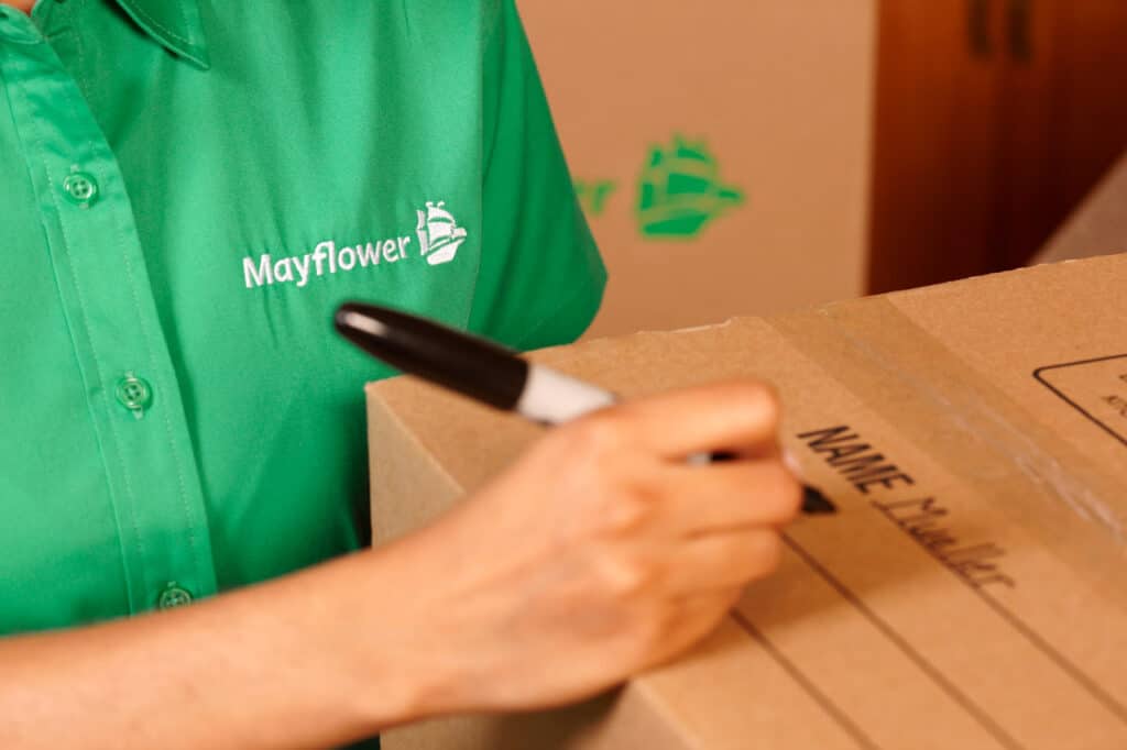 Texas movers with Mayflower Moving Company labeling boxes.