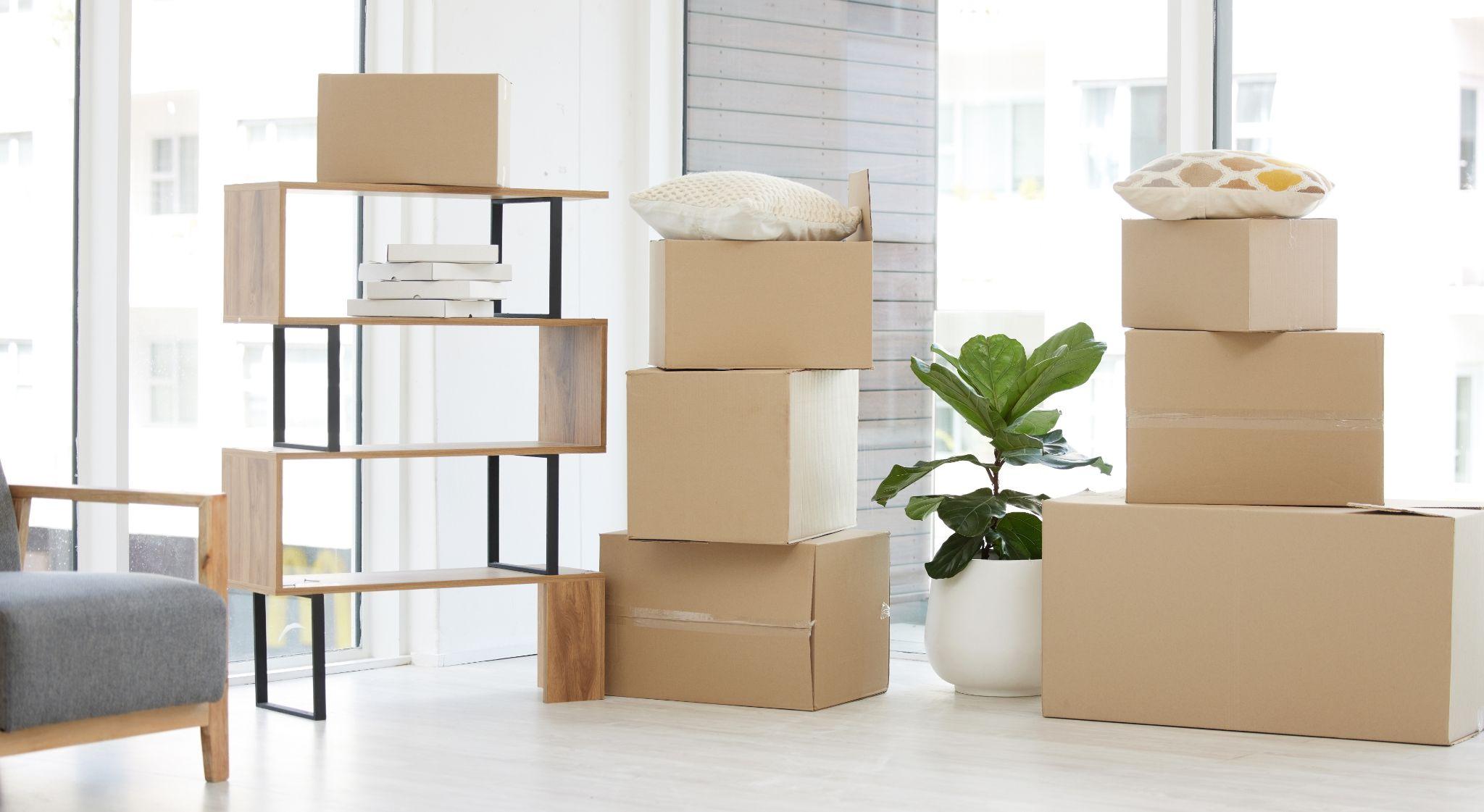 Boxes stacked in an airy room, packed following cost-effective moving strategies.