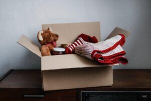An overnight box with a teddy bear, following cost-effective moving strategies.