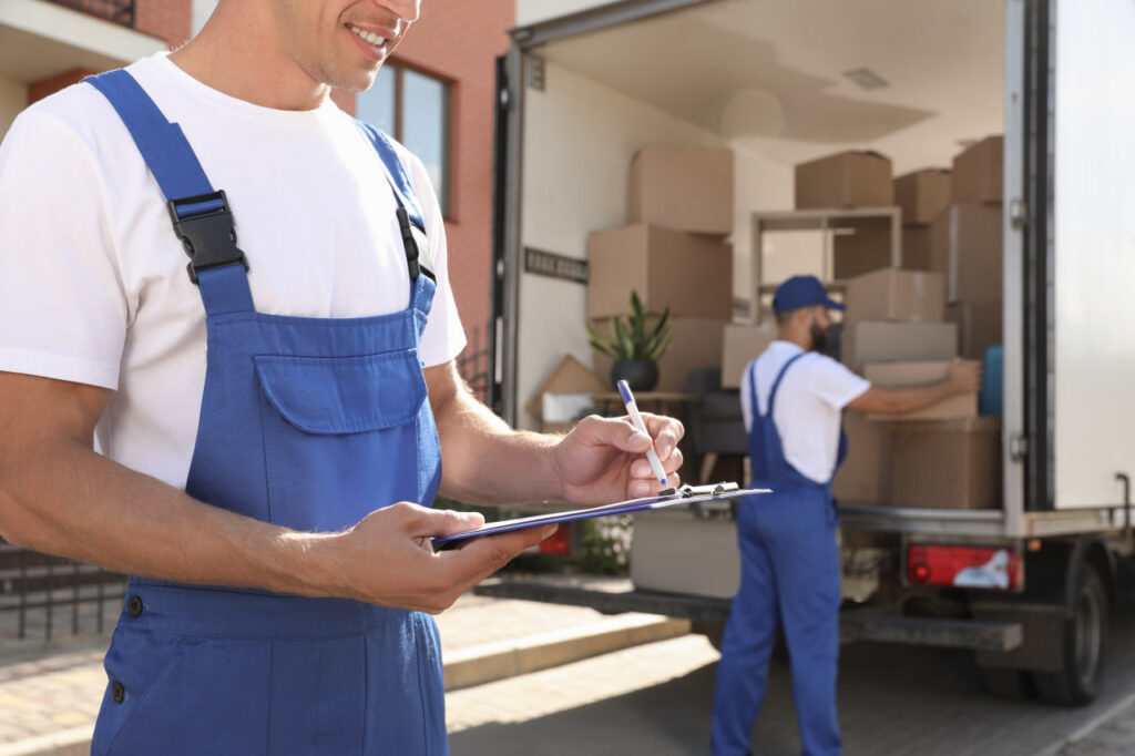 Happy couple watching a full-service moving company implementing end-to-end solutions.