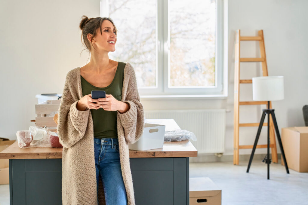 Confident woman drinking coffee after buying back time during a move with end-to-end solutions.